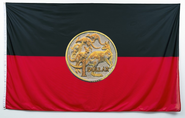 Laurie Nilsen, Dollar Dilemma Flag, 2020, digital print on textile. Installation view, OCCURRENT AFFAIR, UQ Art Museum, 2021. Reproduced courtesy of the artist estate and FireWorks Gallery, Brisbane. Photo: Carl Warner