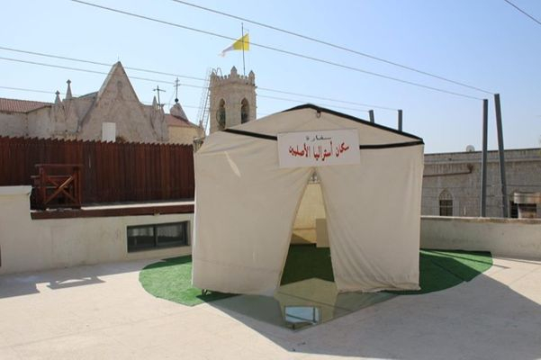 Richard Bell, Embassy 2013, canvas tent with annex, alumninium frame, rope, synthetic polymer paint on ply; Installation view: ‘Embassy’ in 'Frontier Imaginaries,' Jerusalem, 2015. Photograph: Issa Freij.
